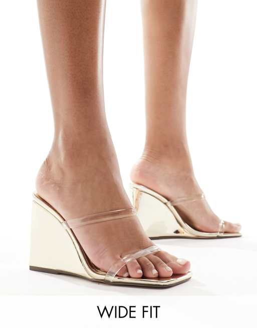 Simmi London Wide Fit Radial wedge heeled sandals in gold with clear straps