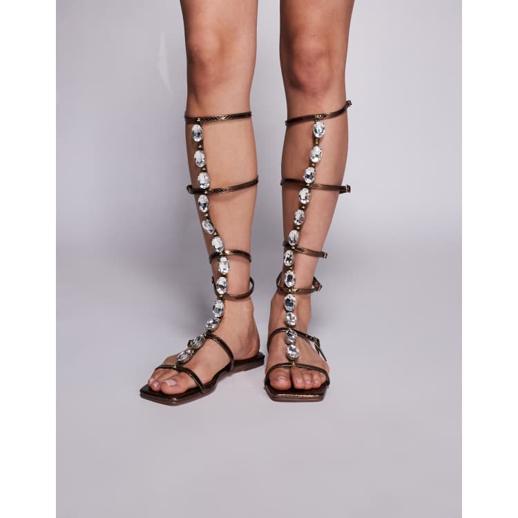 Simmi London Zenya gladiator sandals with stone details in bronze