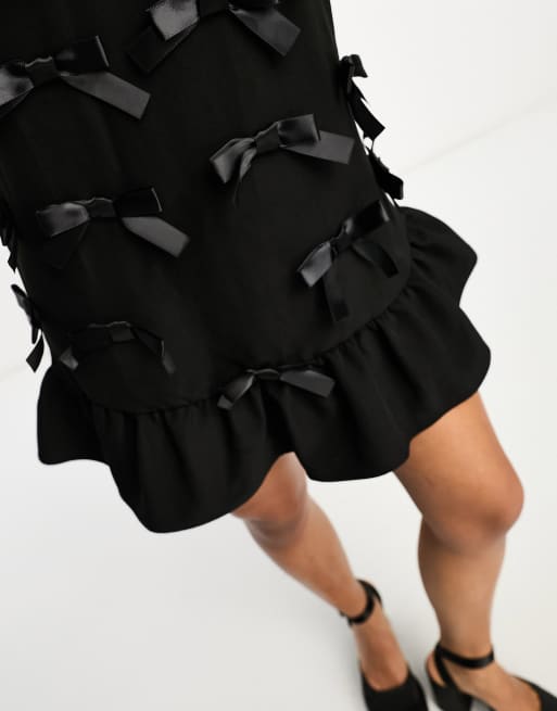 Sister Jane bow embellished mini pinafore dress in black | ASOS