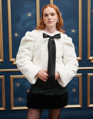 bow front faux fur jacket in cream and black