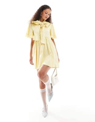 bow ruffle mini dress in yellow