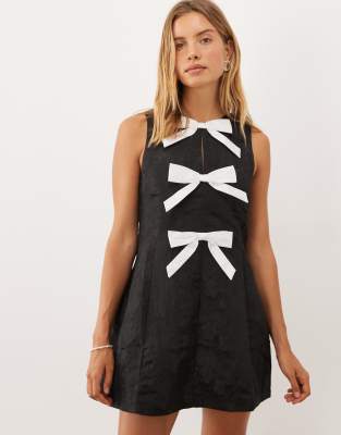 Sister Jane Nova Round Neck Sleeveless Bow Applique Mini Dress In Black