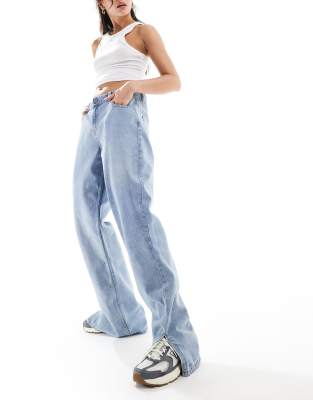 low rise acid wash wide leg jeans with split hem in blue