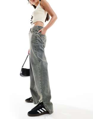 low rise dirty wash wide leg jeans with split hem in blue