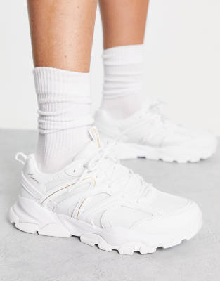 white sneakers with gold trim