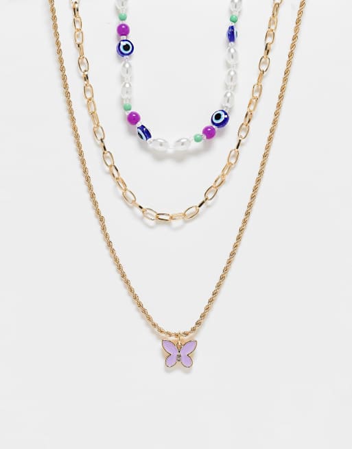 Skinny Dip layered necklace in gold with beaded chocker and butterfly pendant