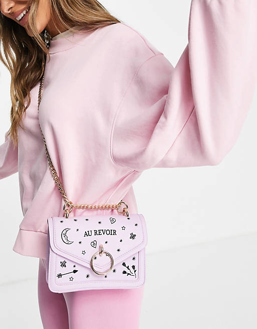 Skinnydip celestial ruthie cross body bag with chain detailing in pink