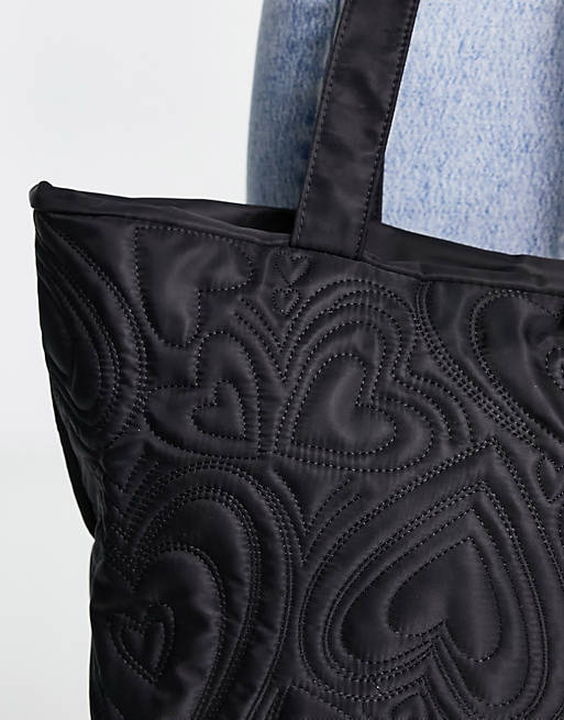Skinnydip padded tote bag in nylon black heart print | ASOS