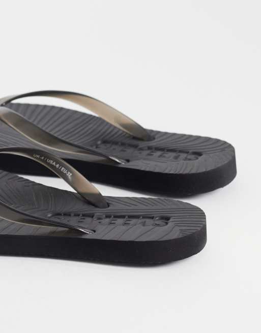 SLEEPERS - Smaltoelopende teenslippers in zwart transparant, 4 van 4