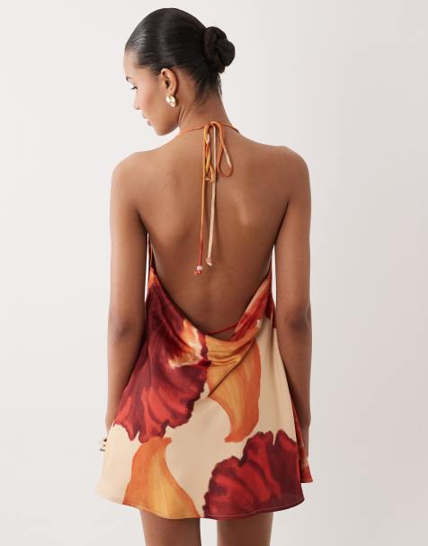 SNDYS – Orange, blommig miniklänning i satin med draperad halterneck och låg rygg - view 1