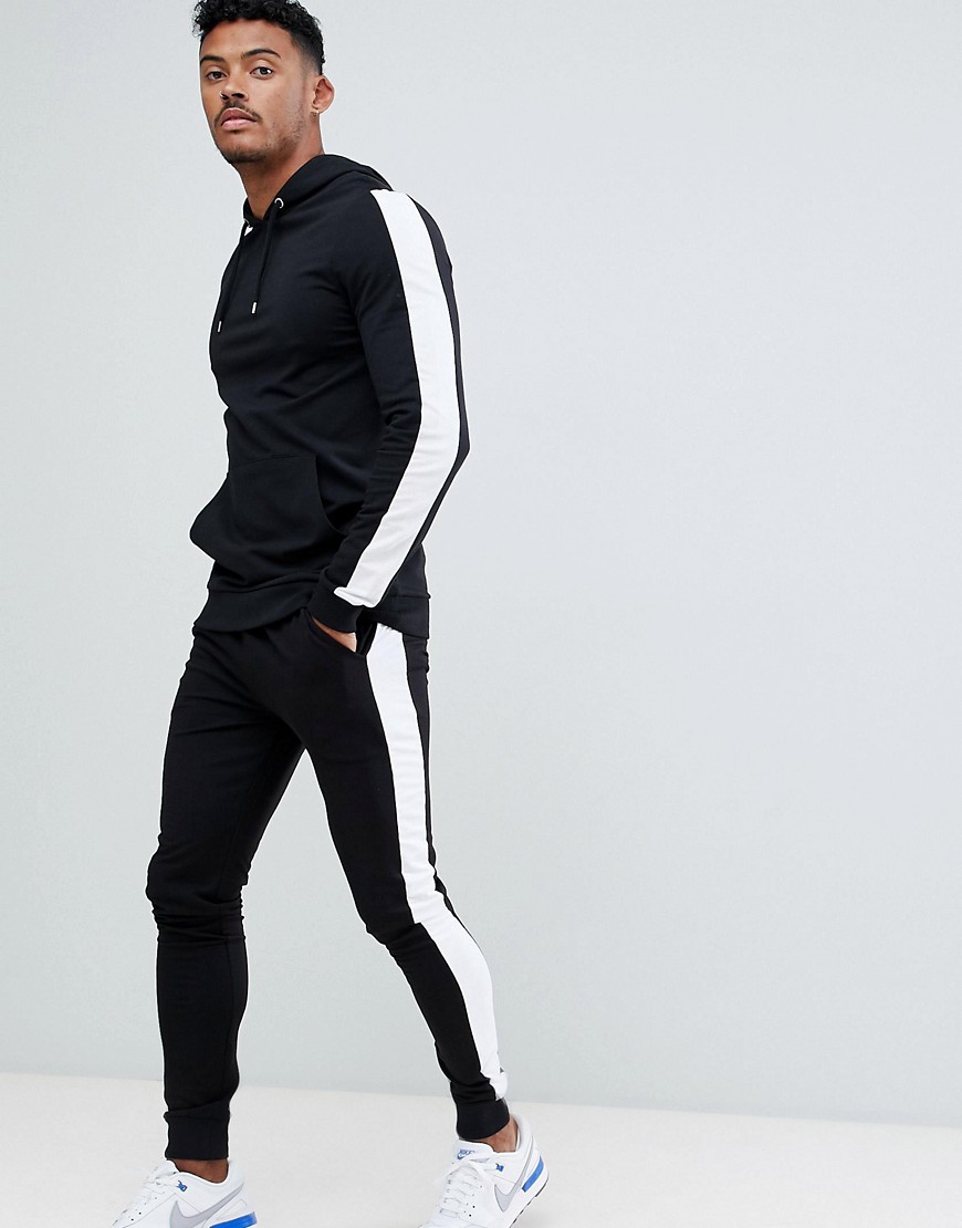 Sort joggingsæt med tætsiddende hættetrøje/ekstra super-skinny joggingbukser med en hvid stribe i siden fra ASOS DESIGN
