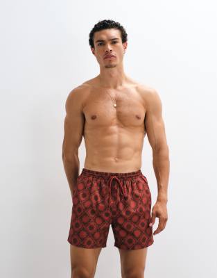 Badeshorts in Rostrot mit Sonnenuhr-Muster Rot M
