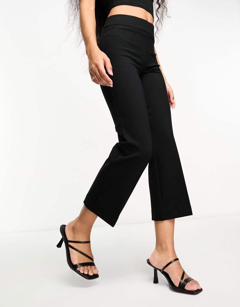 ASOS DESIGN Petite rib flare trouser with lettuce hem in black