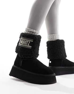 Steve Madden - Ankle-Boots in Schwarz mit flauschigen Manschetten und „St. Moritz"-Schriftzug