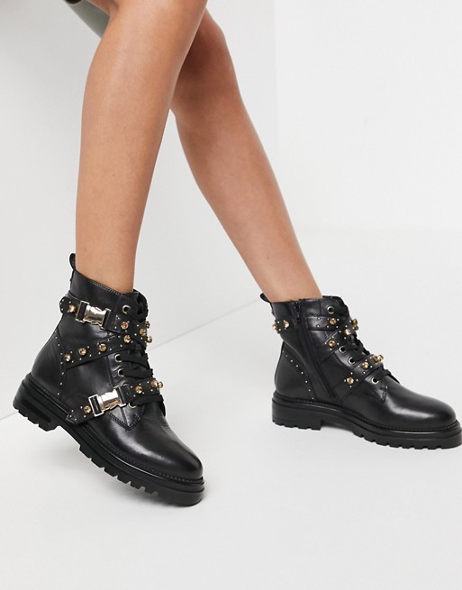 Steve Madden Indra buckle boot with gold hardware in black leather