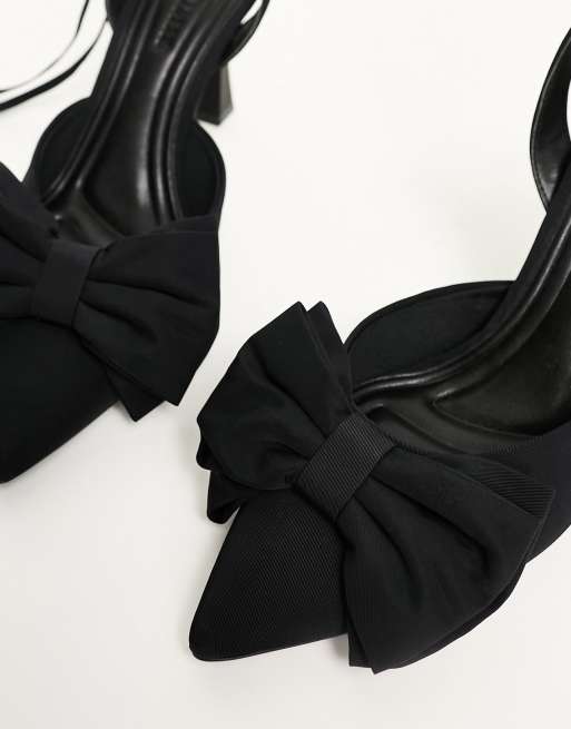 black heels with bow on front