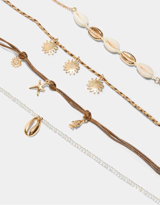 Stradivarius - Confezione di 4 cavigliere color oro con ciondoli