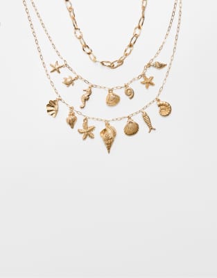 Stradivarius – Guldfärgade halsband med havsinspirerade berlocker, 2-pack