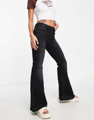 Stradivarius Petite coated flare jean with split hem detail in black