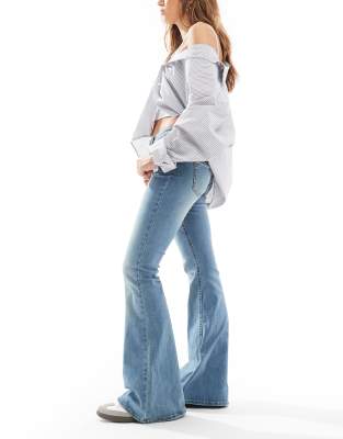 Stradivarius low rise flare jeans in mid blue