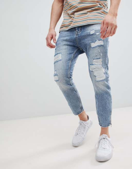 Stradivarius - Lyseblå jeans med gulerodspasform og slidte detaljer samt lynlås