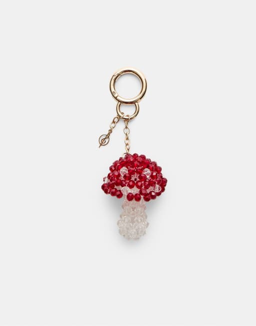 Stradivarius - Portachiavi color oro con charm a forma di fungo rosso