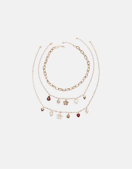 Stradivarius - Set con 3 collane color oro con charm multipli