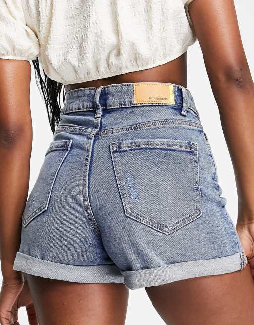 ASOS DESIGN shorter length denim shorts in mid wash with heavy rips