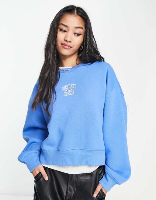 Stradivarius slouchy sweatshirt with embroidered motif in blue | ASOS