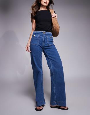 straight leg jeans with button detail in mid blue