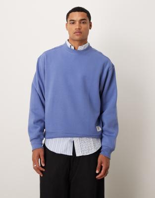 Sudadera azul lavado extragrande con sisas caídas y detalle de etiqueta de tejido de ASOS DESIGN