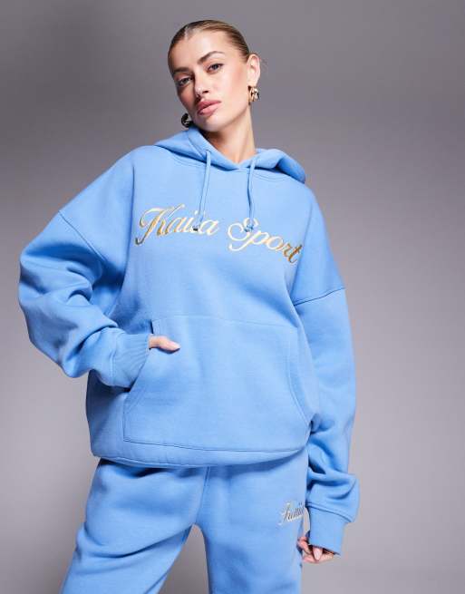 Sudadera azul y amarilla con capucha y logo de texto bordado de Kaiia Sport (parte de un conjunto)