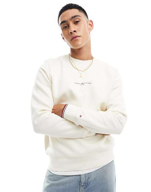Sudadera color crema con cuello redondo, ribetes y logo de Tommy Hilfiger