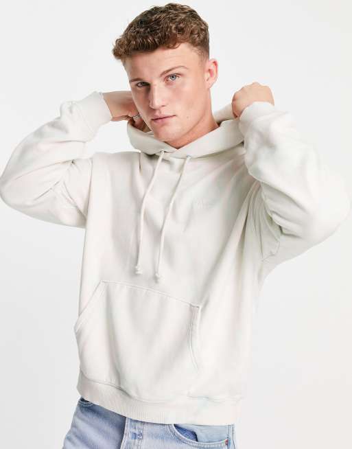 Sudadera coral anaranjado con capucha, efecto tie dye marmoleado y etiqueta roja con logo de Levi's