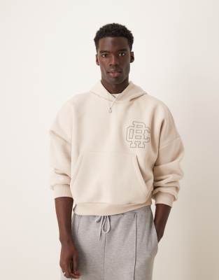 Sudadera corta color avena jaspeado extragrande con capucha, estampado universitario delantero y sisas caídas de ASOS DESIGN