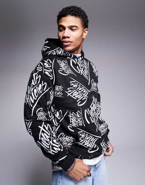 Sudadera negra multicolor con capucha y estampado integral del logo de tejido de 320 g/m2 de Cheats & Thieves - view 1