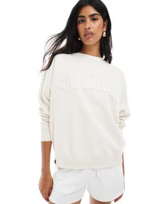 Superdry - Athletic - Basic-Sweatshirt in Wüstenknochen-Wollweiß mit gleichfarbiger Applikation und Rundhalsausschnitt
