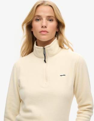 Superdry - Polarfleece-Pullover in Hellbeige mit kurzem Reißverschluss-Weiß