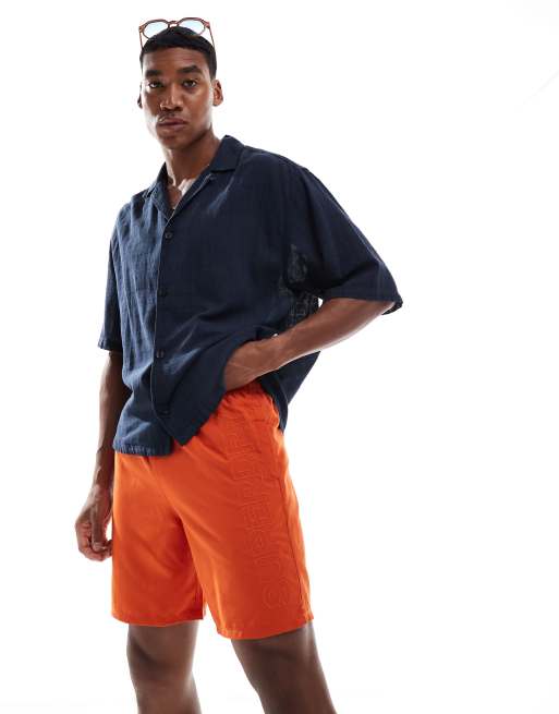 Superdry – Premium – Bestickte Badeshorts in Rust Orange, 17 Zoll Schrittlänge