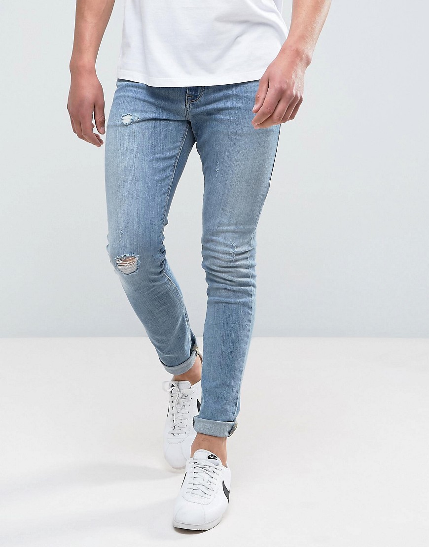 Superskinny medium-forvaskede jeans med slidmærker fra ASOS DESIGN-Blå