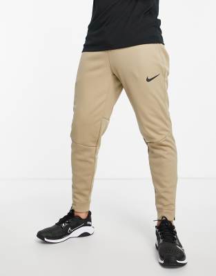 Брюки и меггинсы Светло-бежевые джоггеры Nike Pro Training Therma-FIT Sphere-Светло-бежевый цвет