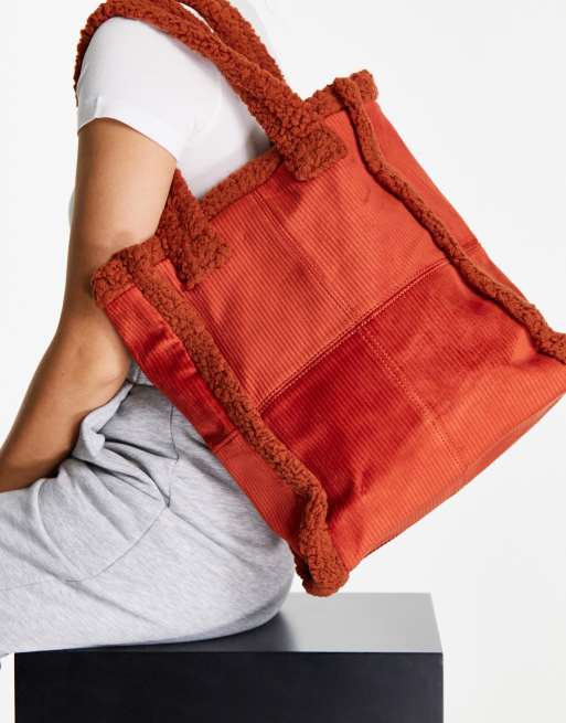 SVNX – Tragetasche in Orange mit Teddyfellbesatz