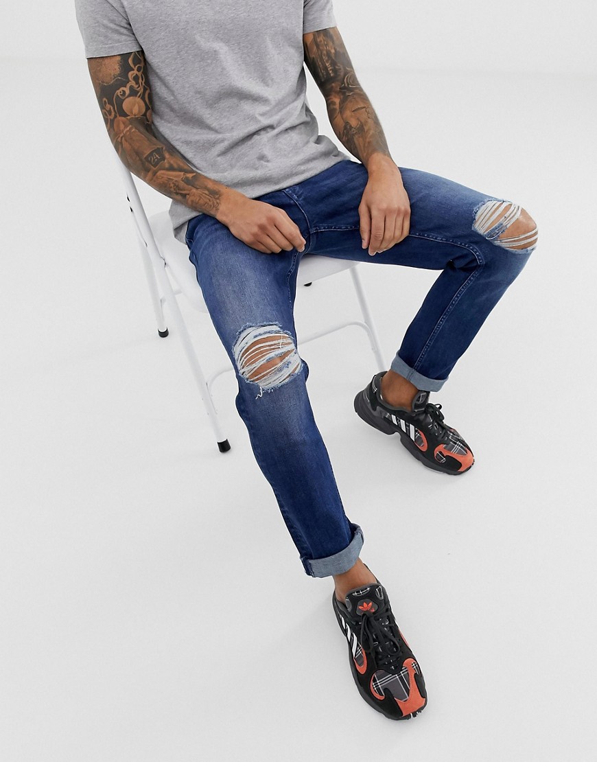 фото Темно-синие узкие эластичные джинсы с рваными коленями asos design-синий