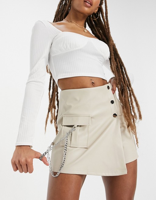 The Couture Club asymmetric buckle detail mini skirt in white