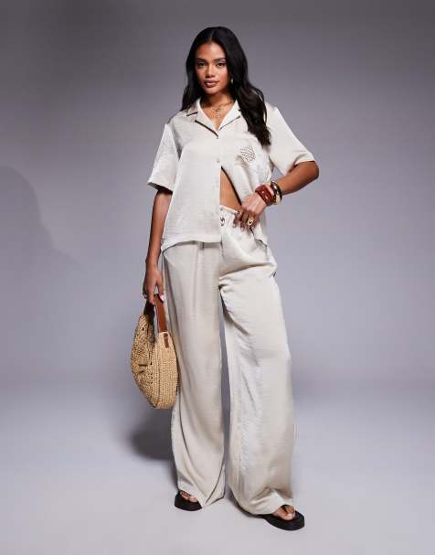 The Couture Club co-ord emblem satin trousers in beige