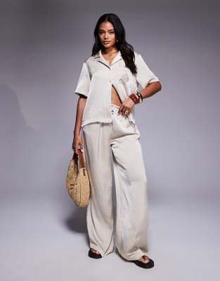 The Couture Club The Couture Club co-ord emblem satin trousers in beige-Neutral
