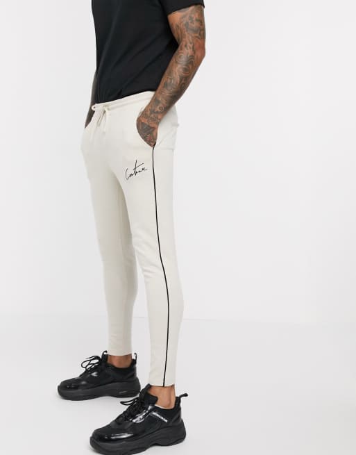 The Couture Club – Elegante Jogginghose mit Hahnentrittmuster in Beige