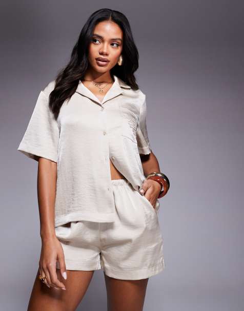 The Couture Club emblem satin shorts in beige - part of a set - view 1