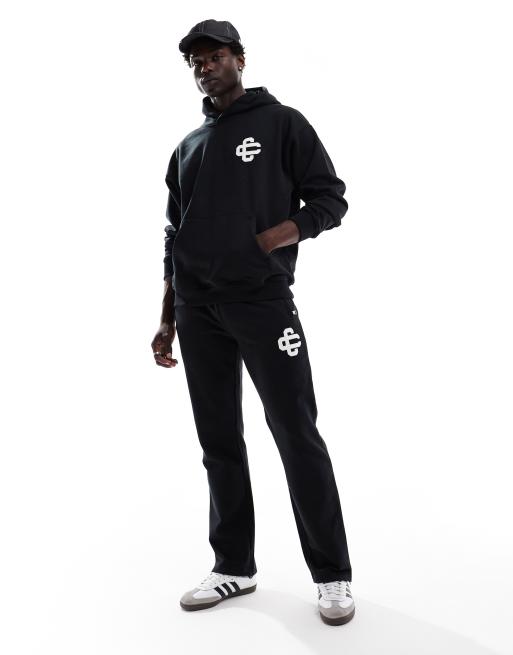The Couture Club heavyweight emblem trackies in black (part of a set) 