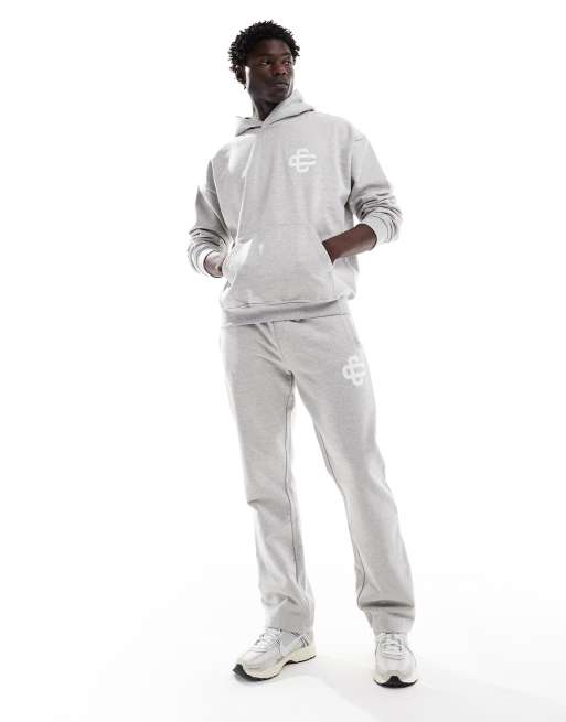 The Couture Club heavyweight emblem trackies in grey (part of a set)